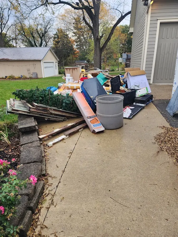 Dumpster being loaded with debris for 12 Yard Dumpster Rental in Allendale